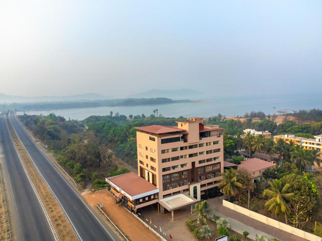 an overhead view of a building next to a highway at Sterling Karwar in Kārwār