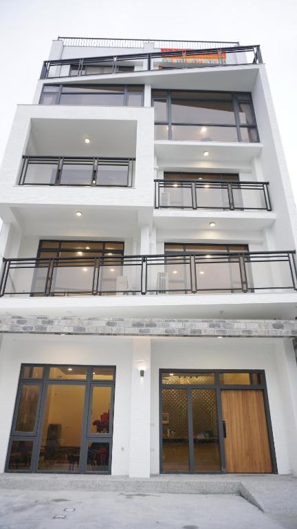a white apartment building with large windows at 晨煦行旅 in Lugu