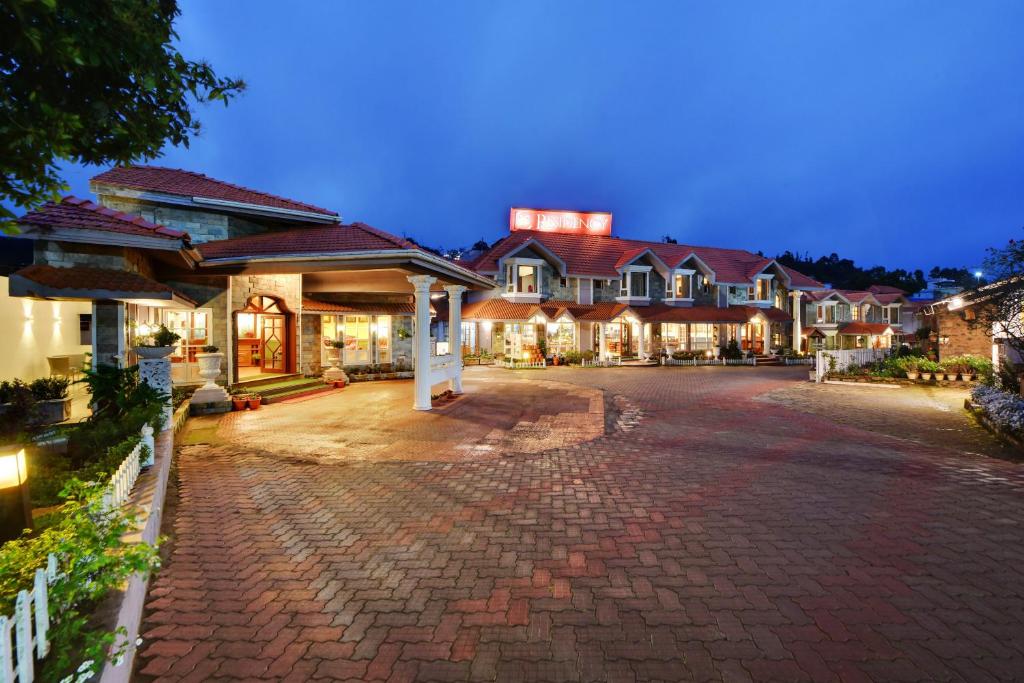 a large house with a driveway at night at JC Residency in Kodaikānāl