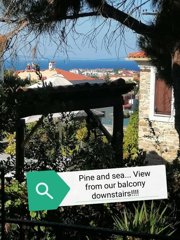 a sign that reads pine and sea view from our balcony downstairs at Pine & sea house in Nikiti