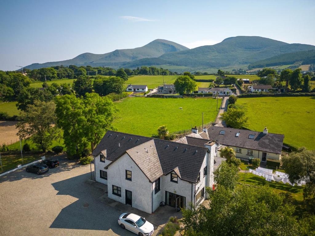 an aerial view of a house with mountains in the background at The Briers Country House in Newcastle