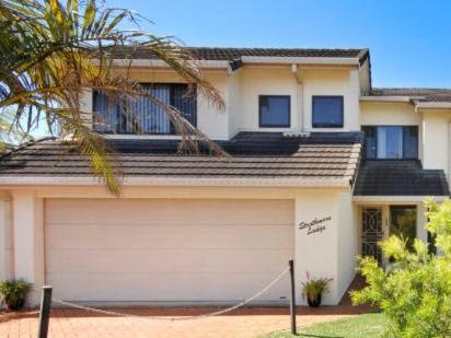 a house with a garage door in front of it at Strathmore Lodge in Port Macquarie