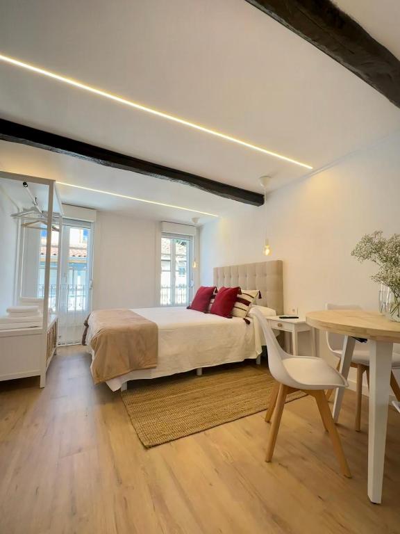 a bedroom with a bed and a desk and a table at N&E - Home Celanova Rúa Manuel Lezón in Celanova