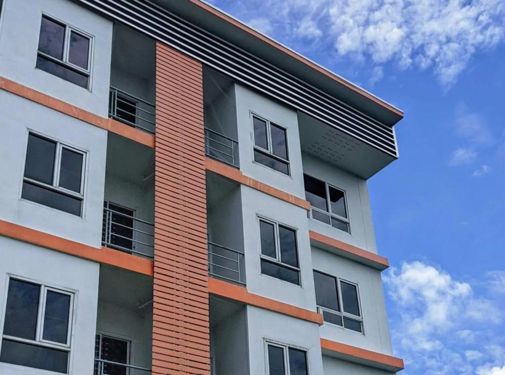 a tall apartment building with a sky in the background at V at Panus in Phanat Nikhom