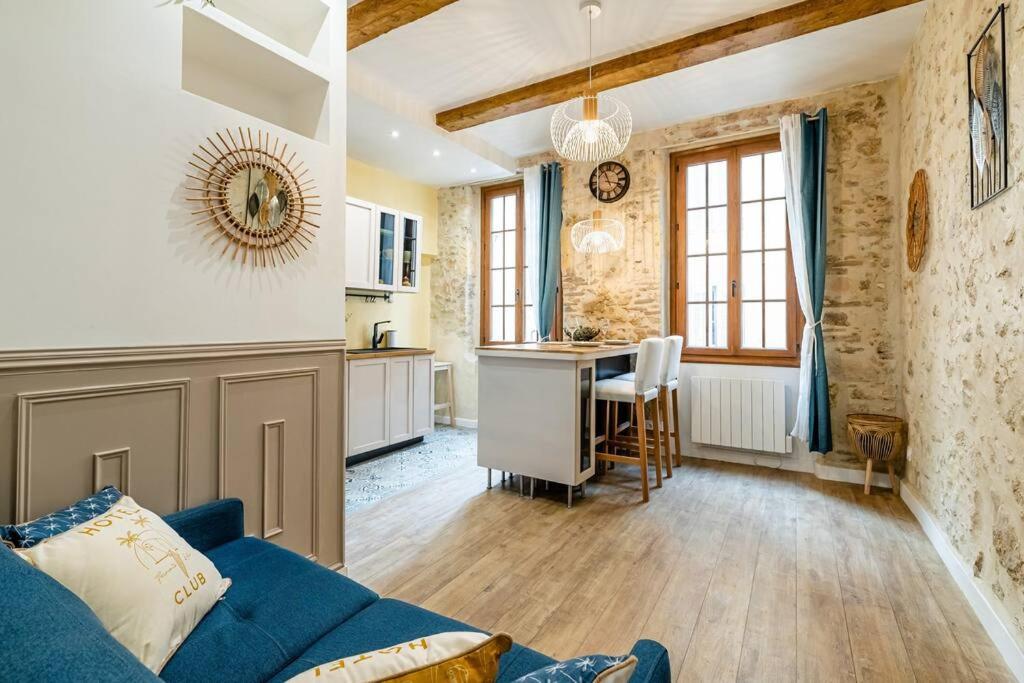 un salon avec un canapé bleu et une cuisine dans l'établissement L’Authentique à Marseille, à Marseille