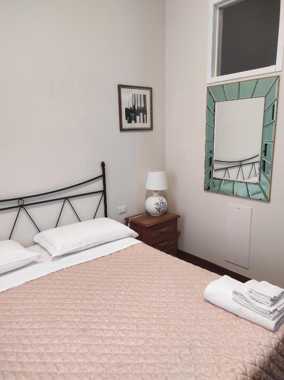 a bedroom with a large bed and a mirror at Interno 12 - L'Aquila in LʼAquila