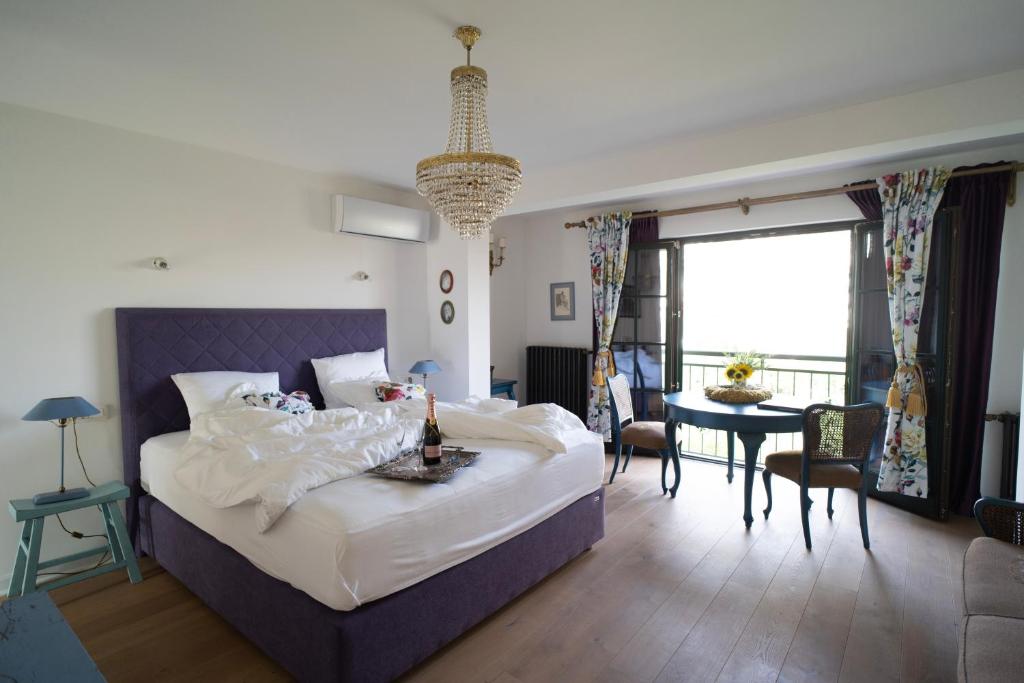 a bedroom with a large bed and a living room at Nomad Rooms in Mostar