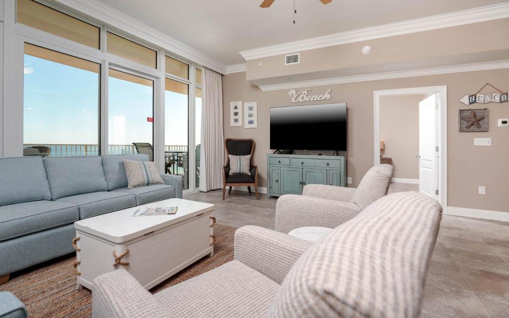 a living room with a couch and a tv at Phoenix Orange Beach II 1104 in Orange Beach