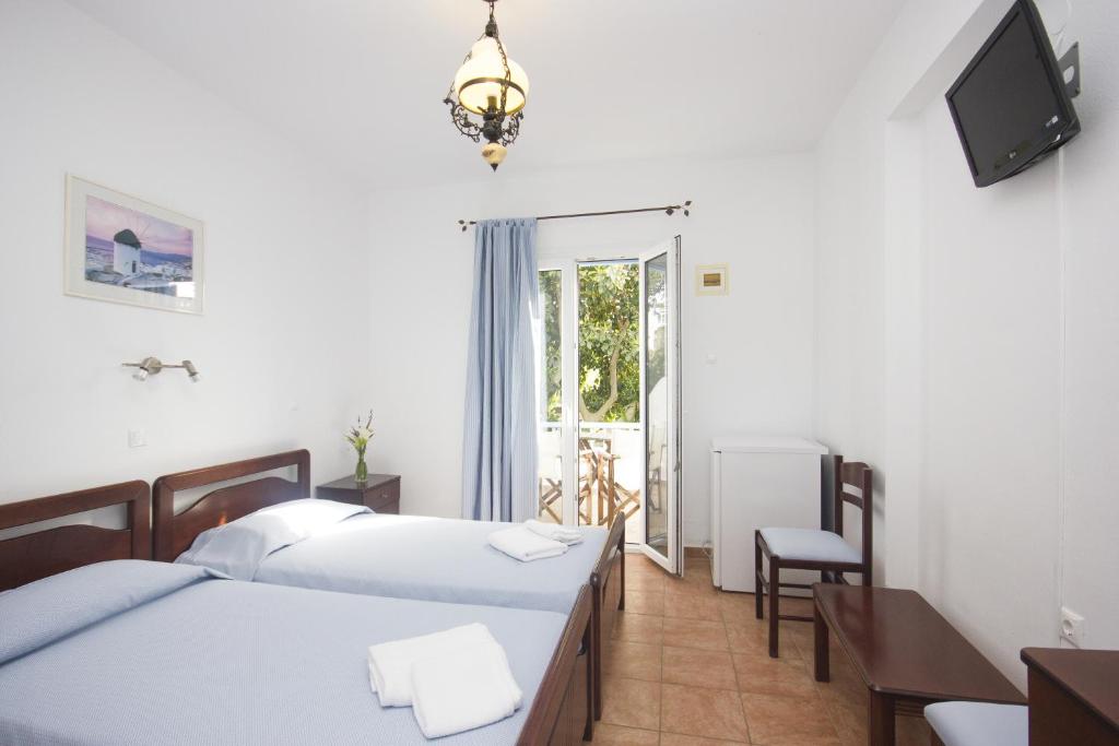 Postel nebo postele na pokoji v ubytování Sourmeli Garden Hotel