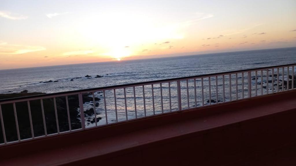 a view of the ocean from a balcony at sunset at Beiramar4 in Muxia