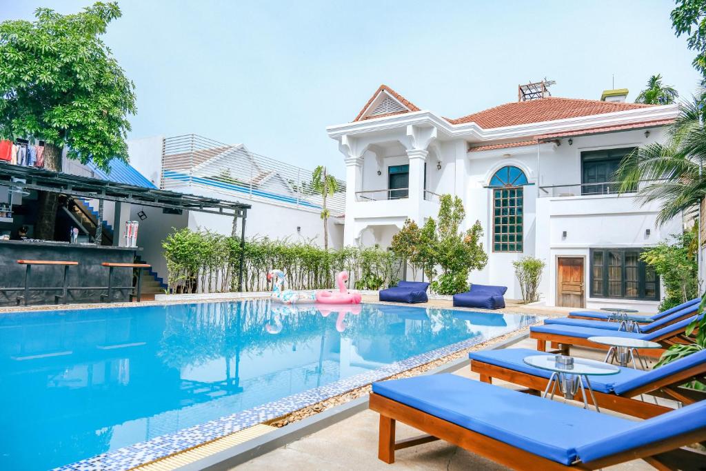 a villa with a swimming pool and a house at The Big Easy Siem Reap in Siem Reap