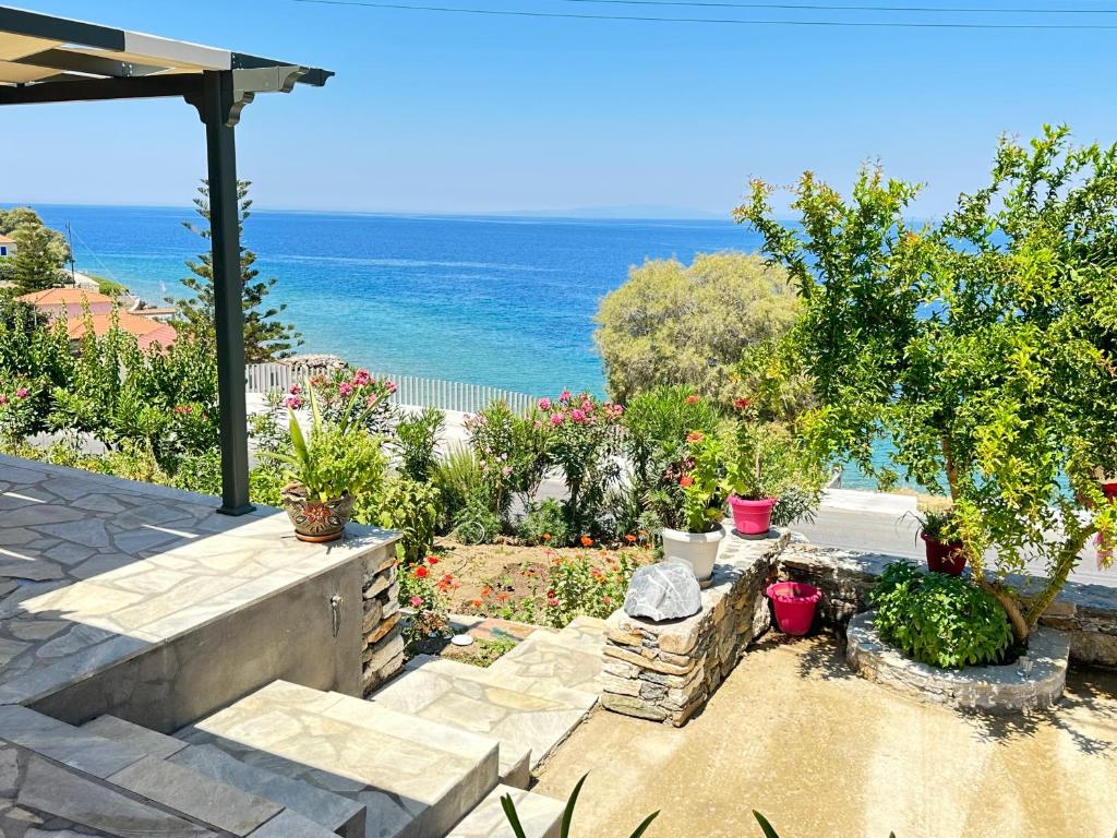 a garden with a view of the ocean at Maroudio's Villa in Livadáki