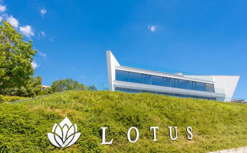 a building with a lotus sign in front of it at Lotus Luxury Rooms in Varna City