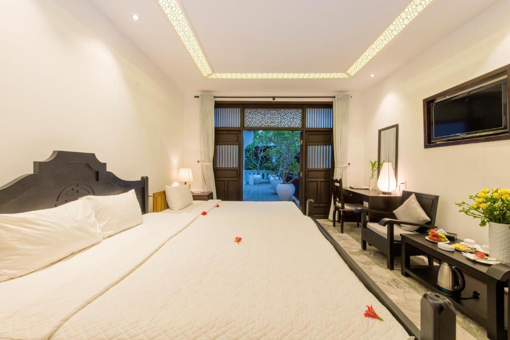 Postel nebo postele na pokoji v ubytování Hoi An Ancient House Resort & Spa