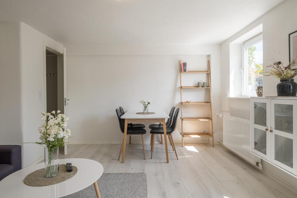a living room with a table and chairs at Newly renovated 1-Bed Apartment in Aalborg in Aalborg