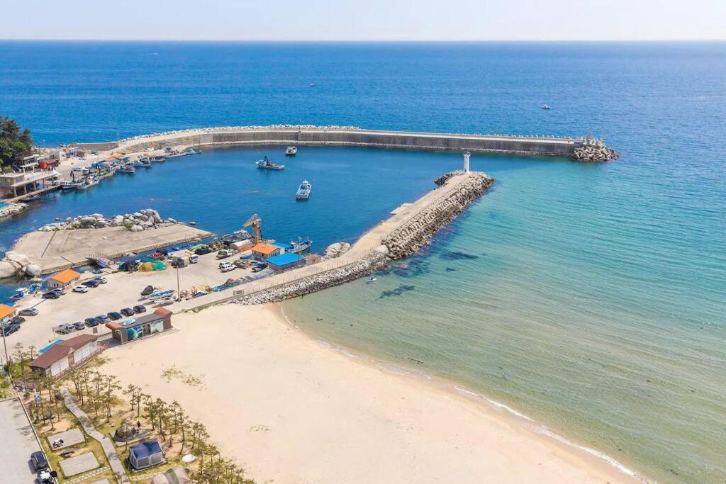 an aerial view of a beach with a pier at Yangyang Ocean Stay in Yangyang