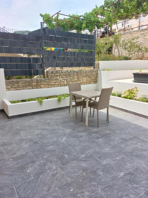 a patio with a table and chairs on it at Apartment Karlo, Pula in Pula