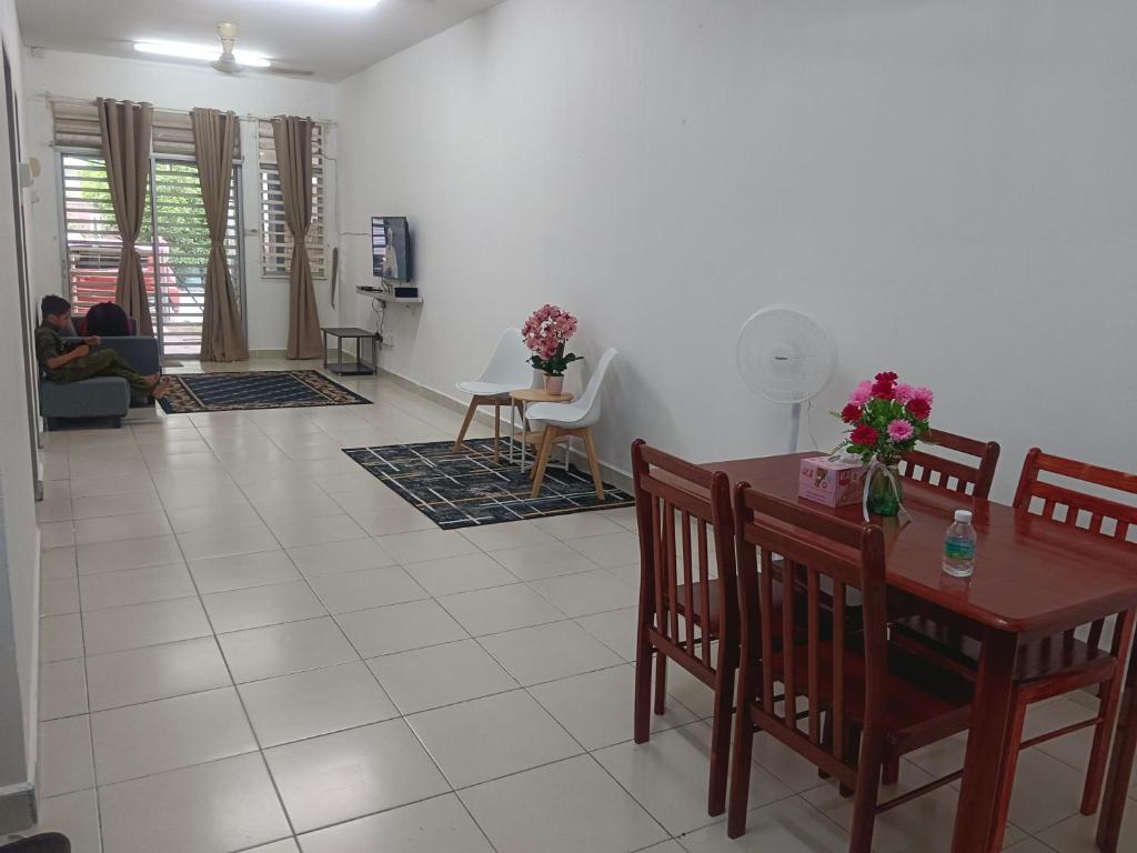 een woonkamer met een tafel en stoelen bij Afna Homestay 2 in Kuala Lipis