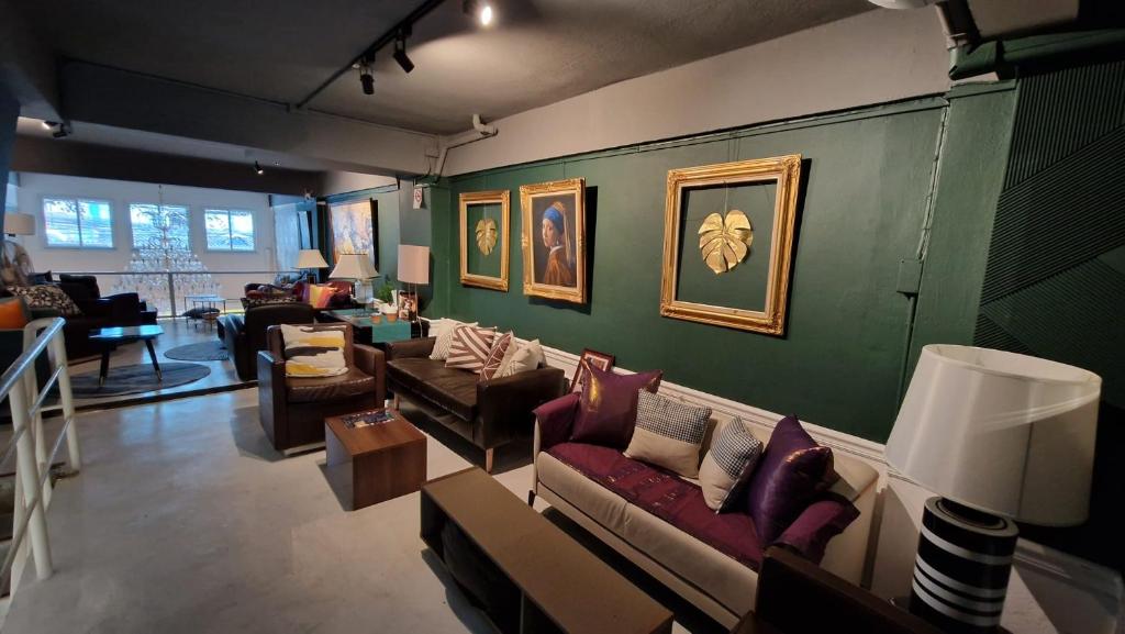 a living room filled with couches and chairs at Cozy chic Silom townhouse studio 2-4 in Bangkok