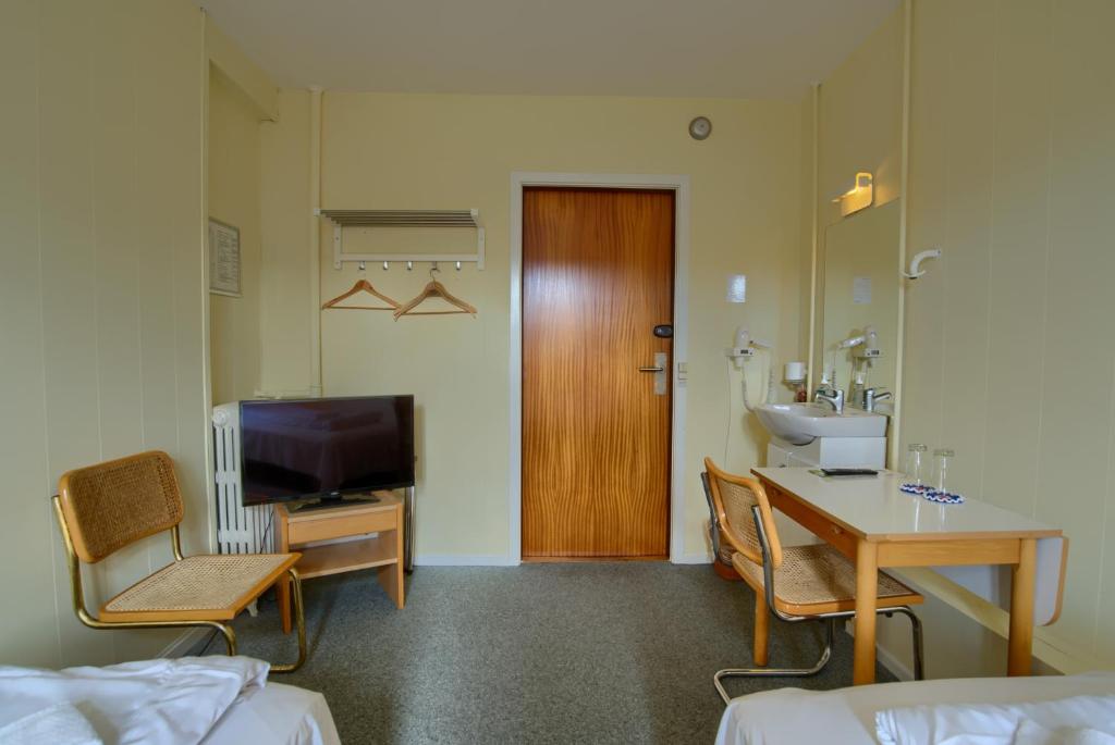 TV a/nebo společenská místnost v ubytování Ebsens Hotel