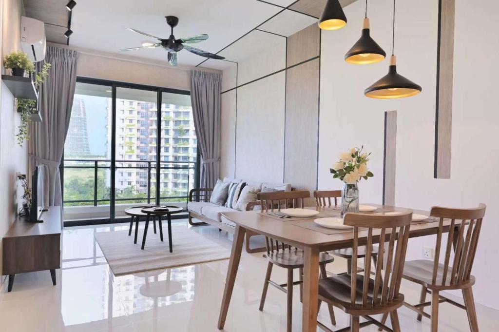 a dining room with a table and chairs and a large window at 09 forest city homestay-温馨小筑 in Johor Bahru