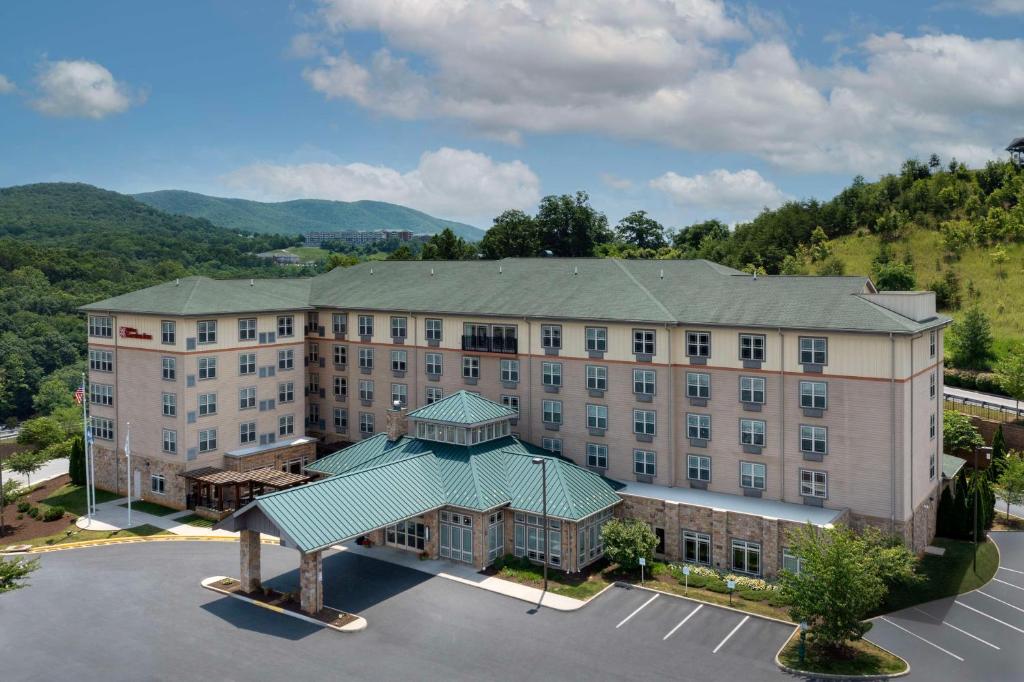 an aerial view of a hotel building with a parking lot at Hilton Garden Inn Roanoke in Roanoke