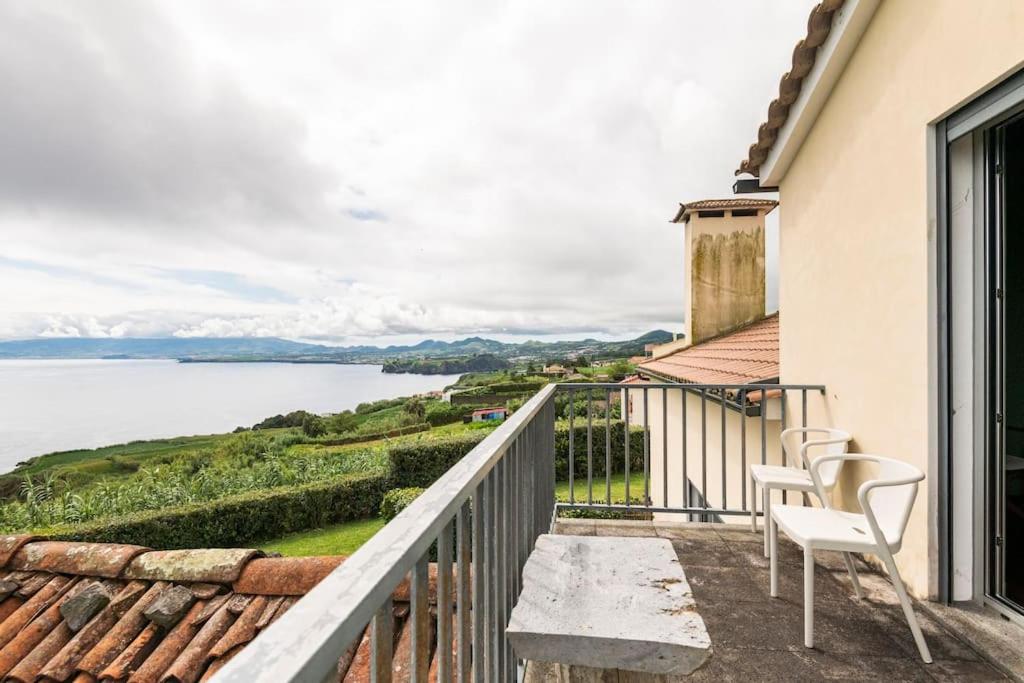 a balcony with chairs and a view of the water at Casa da Vigia in Santo António