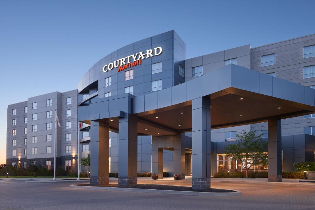 a building with a sign on the front of it at Courtyard by Marriott Calgary Airport in Calgary