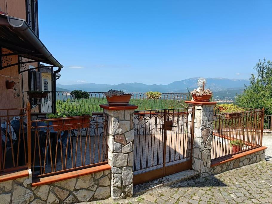 a gate with two potted plants on top of it at Guardando le Mainarde 