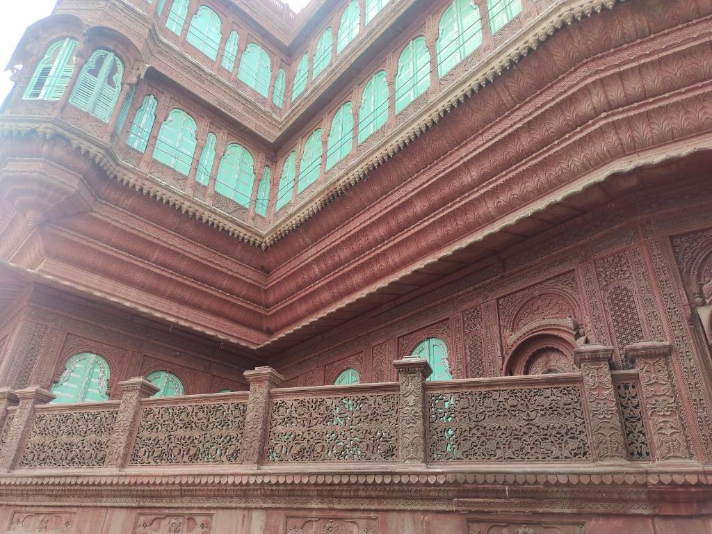 a balcony of a building with windows on it at Little prince guest house & homestay in Bikaner