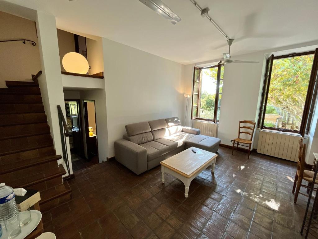 a living room with a couch and a table at Le Mas Saint Jacques in Le Pontet