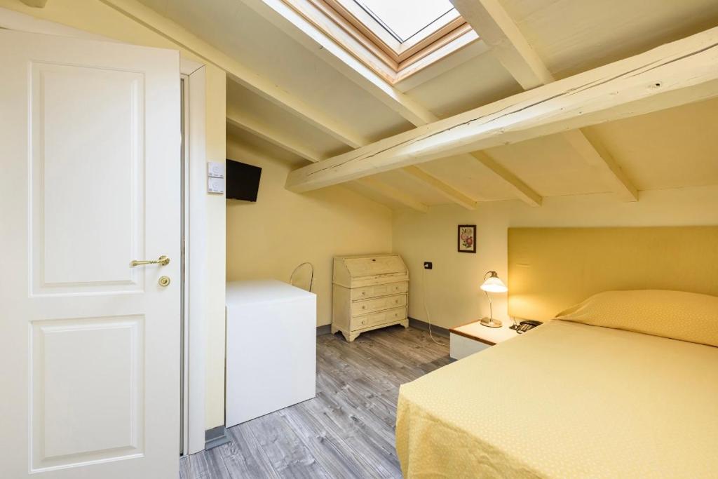 a bedroom with a bed and a skylight at B&B Casa Rossa in Florence