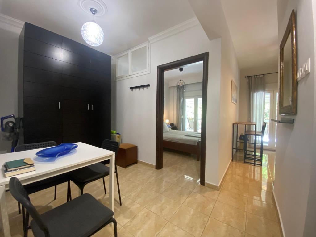 a dining room with a table and chairs and a room at Norra Apartments in Thessaloniki