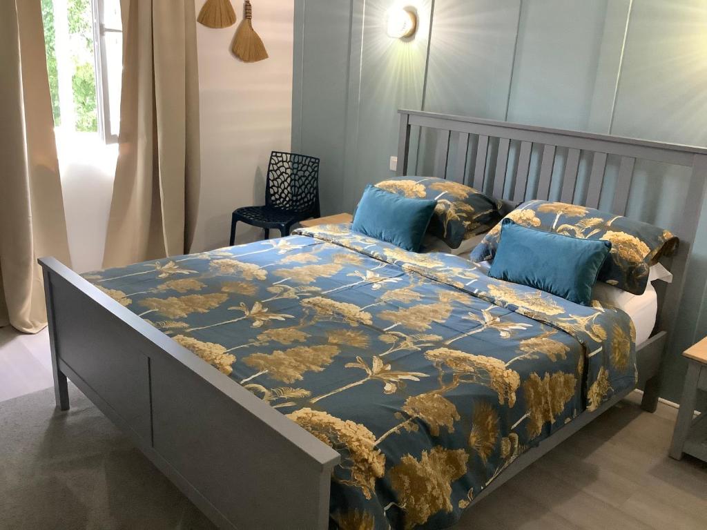 a bedroom with a bed with a blue blanket and blue pillows at No. 5 Plaisance in Plaisance