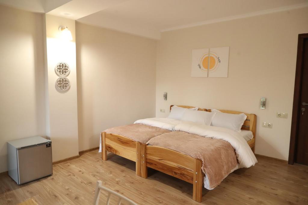 a bedroom with a large bed with white sheets and pillows at h’Olarooms N3 in Tʼianetʼi