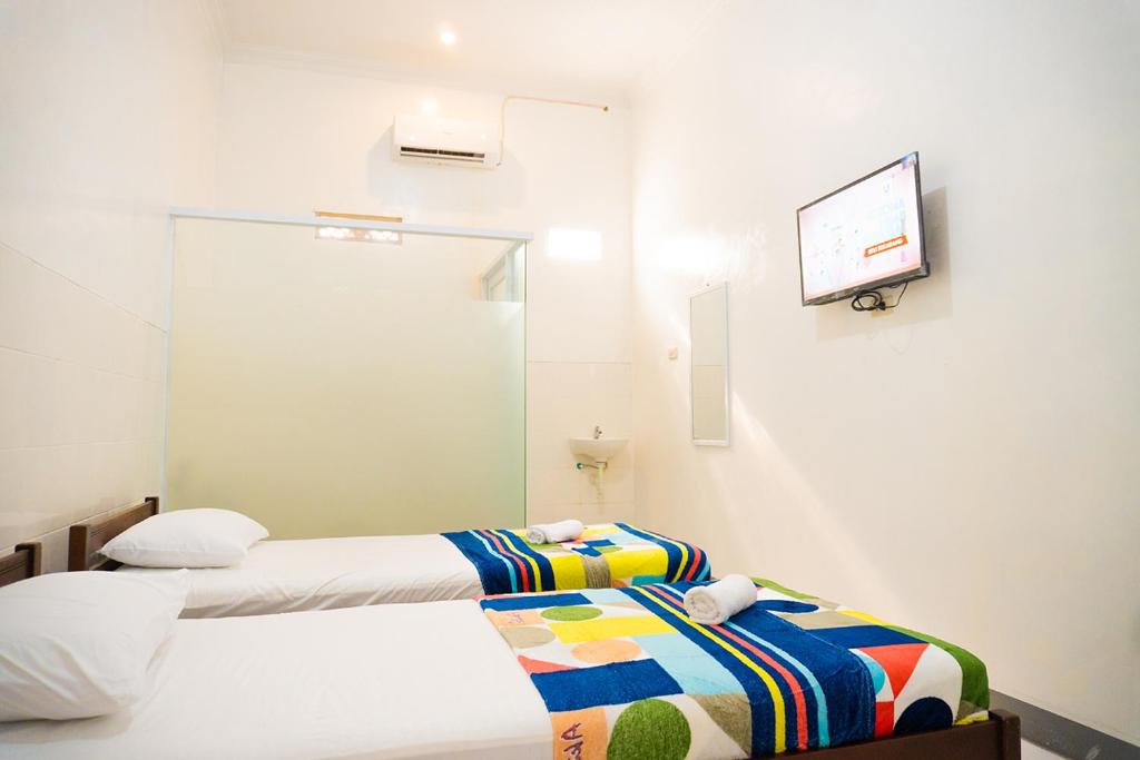 Letto o letti in una camera di Jo&Jo Hostel SYARIAH