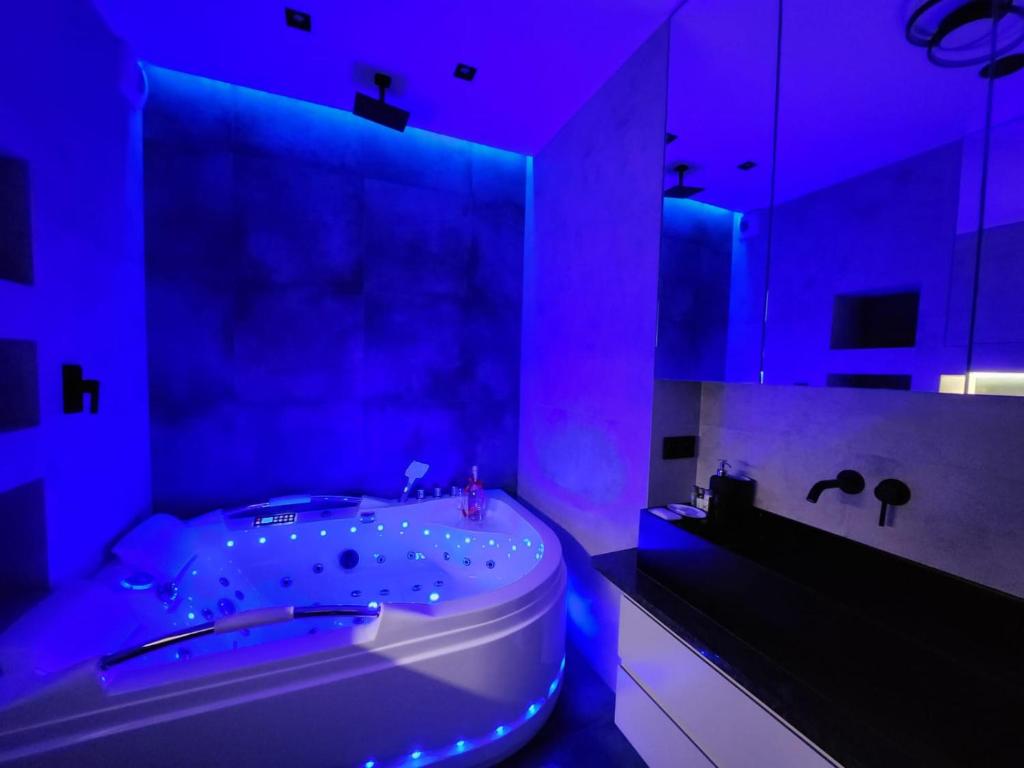 a bathroom with a tub with purple lights in it at CENTRAL HOUSE - Studios with exclusive use of a Jacuzzi and optional Prosecco with full access to sauna, gym and play pool facilities - Studia z prywatnym Jacuzzi i opcją z Prosecco oraz dostępem do sauny, siłowni i bilarda in Warsaw