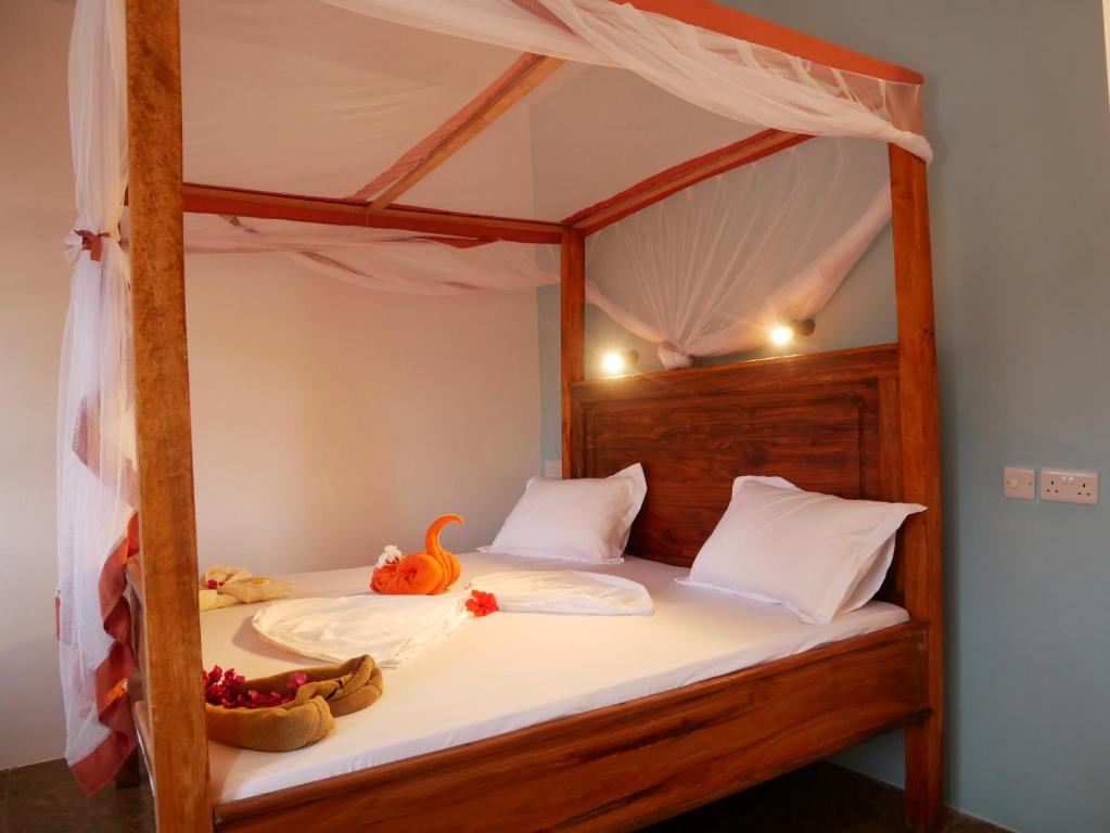 Postel nebo postele na pokoji v ubytování Sabali Lodge, Zanzibar