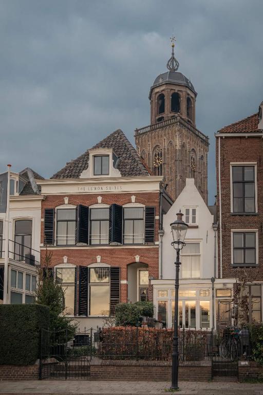 a building with a clock tower and a church at The River Suites in Deventer