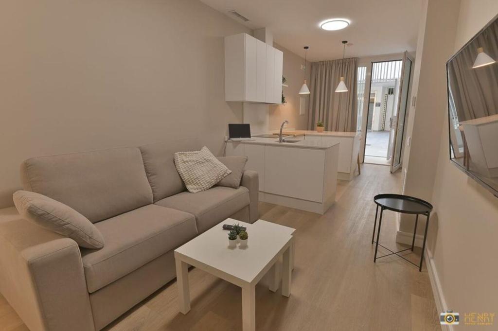 - un salon avec un canapé et une table dans l'établissement Apartamentos Bela, à Cangas
