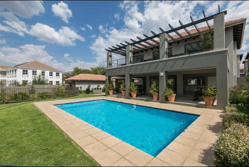 a swimming pool in the yard of a house at Fourways Luxe Suite in Sandton