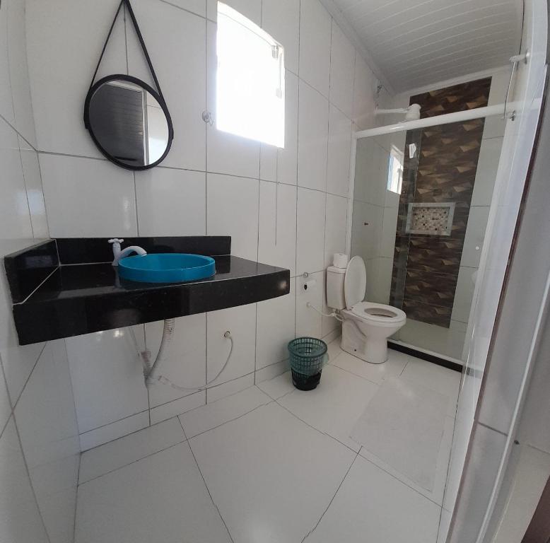 a bathroom with a sink and a toilet at Pousada Lagoa Azul in São Pedro da Aldeia