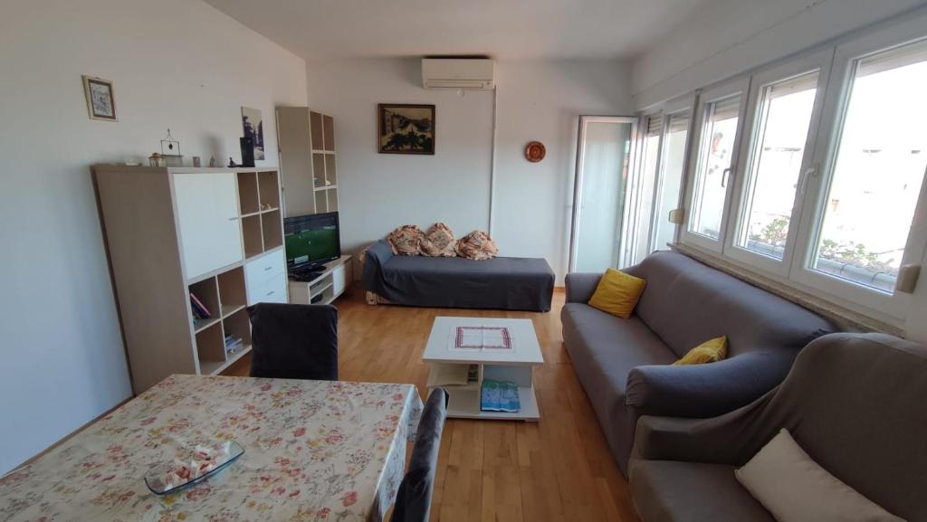 ein Wohnzimmer mit einem Sofa und einem Tisch in der Unterkunft Apartment Marina in Zadar