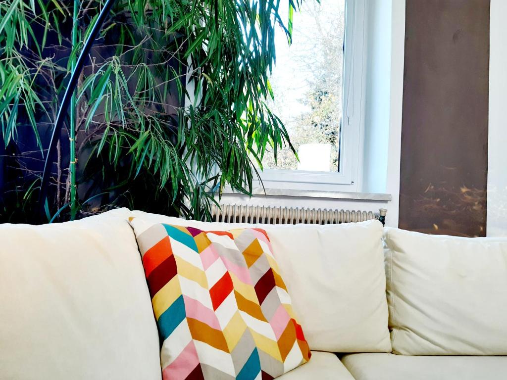 a white couch with a colorful pillow on it at Große Altbauwohnung auf dem Land in Kallham