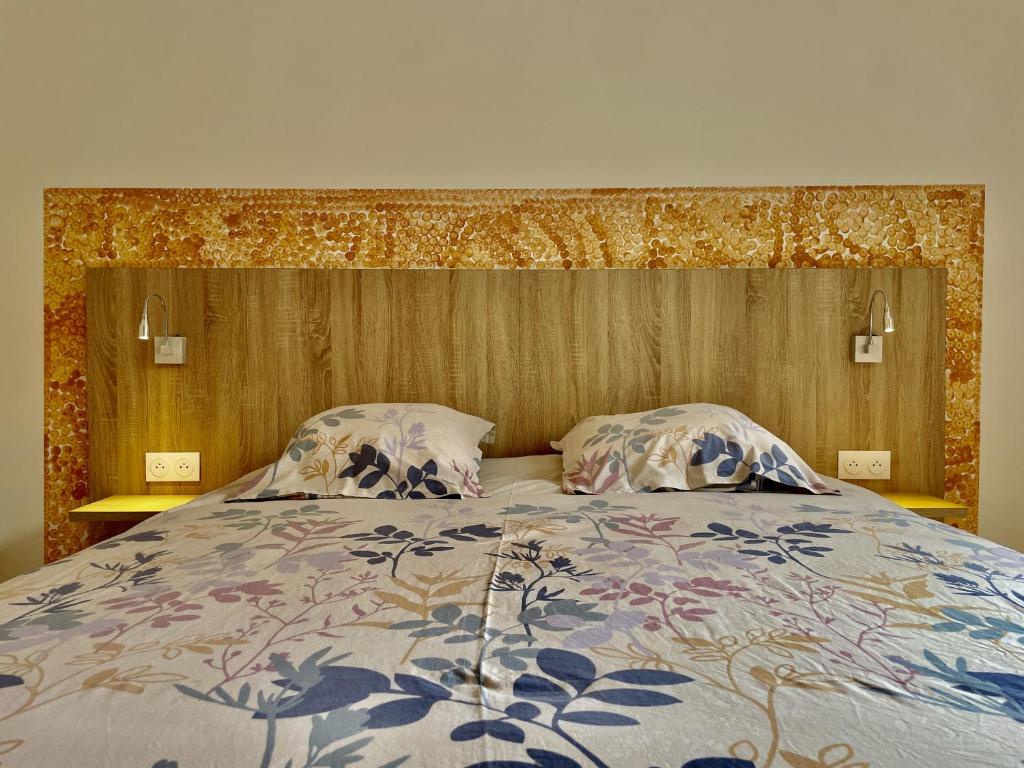 a bedroom with a large bed with two pillows at Alba in Laxou