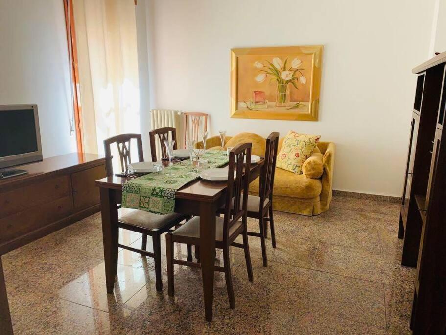 a dining room with a table and chairs and a couch at Curtatone 170 in Vittoria