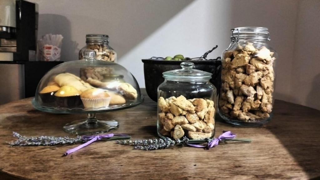 a table with jars of nuts and a bowl of cookies at AGRITURISMO TERRAPIA in Moscufo