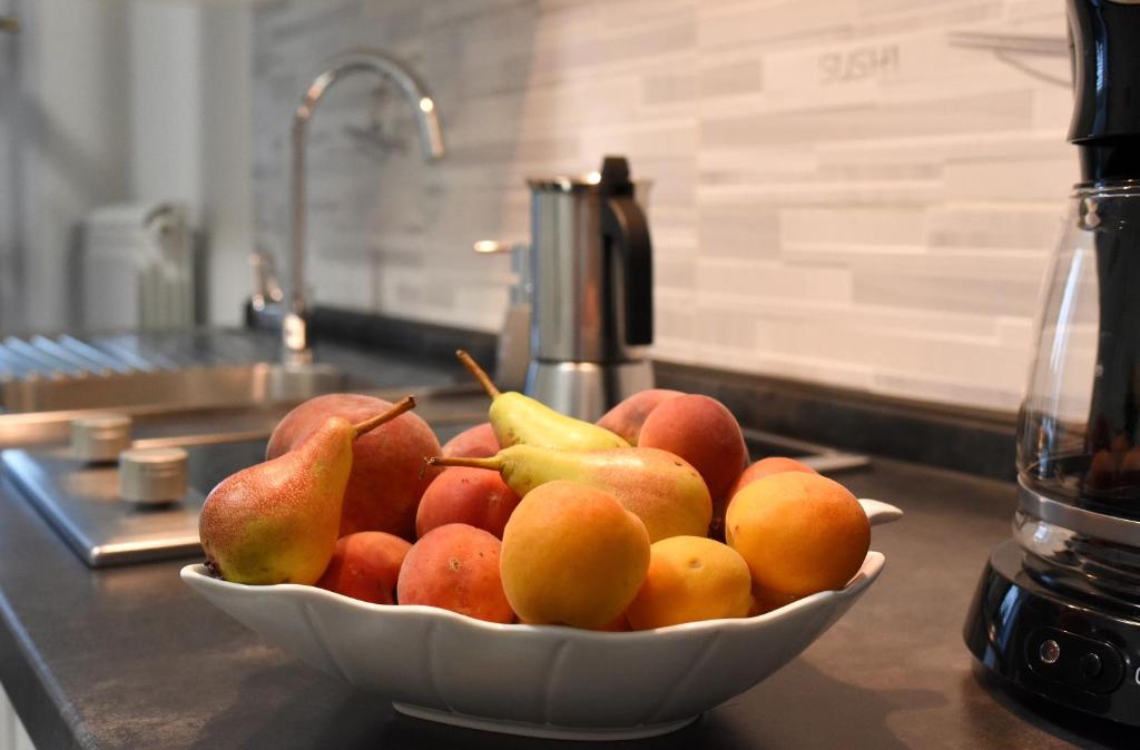 a bowl of fruit on a counter in a kitchen at Apartment Ivana in Roč