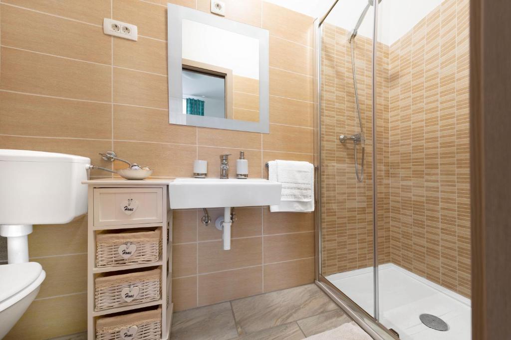 a bathroom with a sink and a shower at Apartment Ivana in Roč