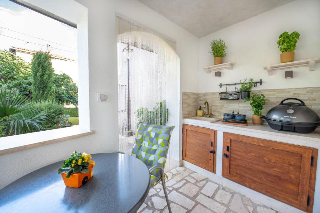 a kitchen with a table and a window and a table at Apartment Ivana in Roč
